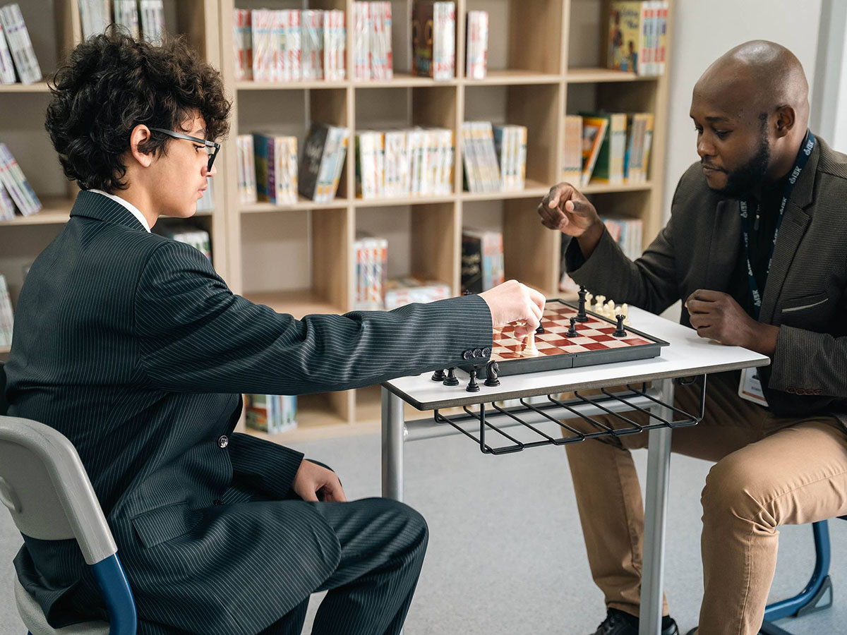 ISK student challenging a teacher to a game of chess